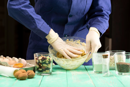 Cooking oatmeal cookies with nuts and candied fruit sweet nutritious dessert.の写真素材
