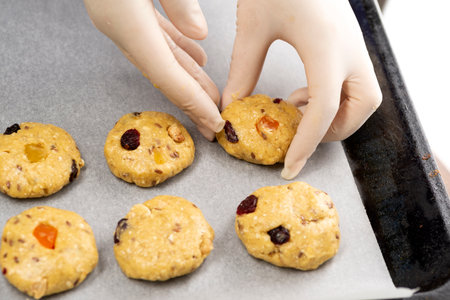 Oatmeal cookies with candied fruits on a baking sheet.の写真素材