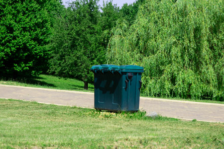 Plastic trash container in a city park on a summer sunny dayの写真素材