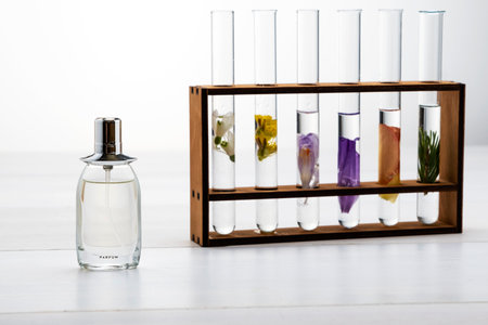 Fresh flowers in chemical test tubes on the table. Preparation of perfumes from natural ingredients, aromatherapyの写真素材