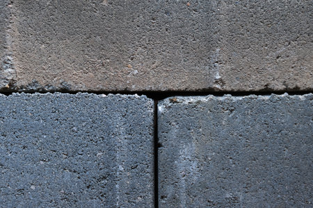 Gray building cinder blocks made of cement stacked close-up background. Lot of large concrete bricks stacking textureの写真素材