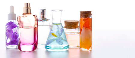 Preparation of perfumes from natural ingredients, aromatherapy. Fresh flowers in chemical flasks and perfume bottlesの写真素材