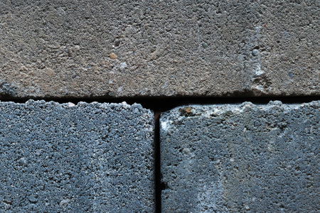 Gray building cinder blocks made of cement stacked close-up background. Lot of large concrete bricks stacking texture.の写真素材