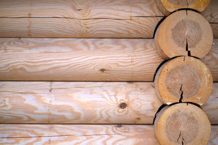 Natural background pattern of log wall. Construction of houses made of wood, rounded timber.の写真素材