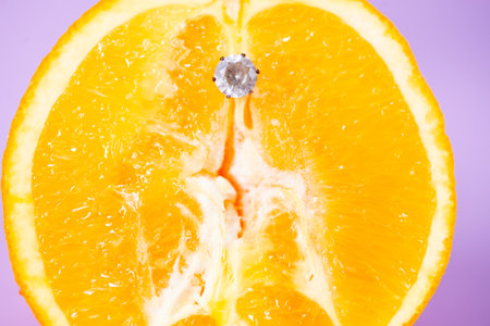 Orange slice with decorative metal element, creative conceptの写真素材