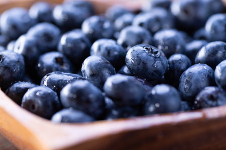 Fresh blueberries close up on a wooden plateの写真素材