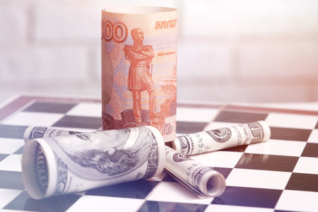 Russian rubles and American dollars on a chessboardの写真素材