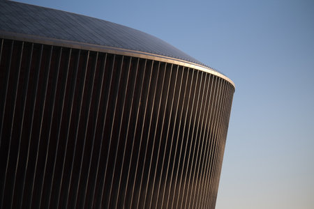 Cladding of a modern sports stadium against a blue skyの写真素材