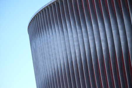Cladding of a modern sports stadium against a blue skyの写真素材