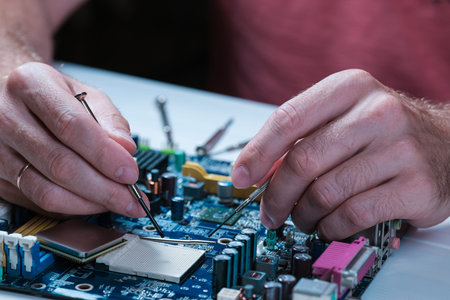 A master repairs a motherboard from a computer