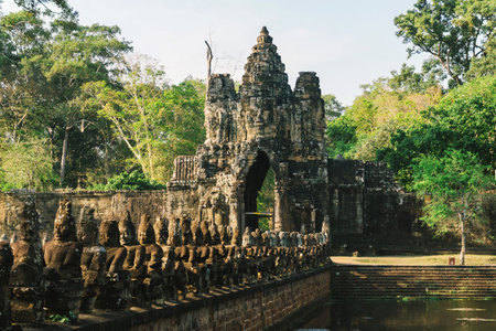 Row of sculptures in the South Gate of Angkor Thom complex. Siem Reap, Cambodia.Angkor wat in the...