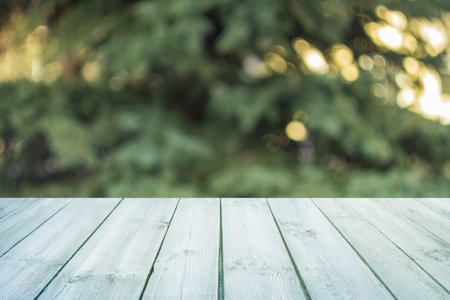 Empty blue wooden table with blurred city park on background. concept party, products, spring...