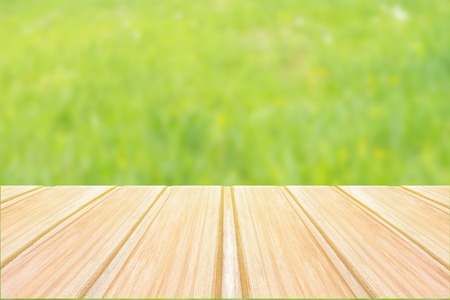 Empty blue wooden table with blurred city park on background. concept party, products, spring backgroundの写真素材