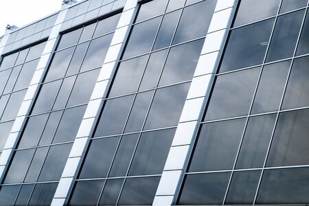 close-up of a modern glass building with square blue glassの写真素材