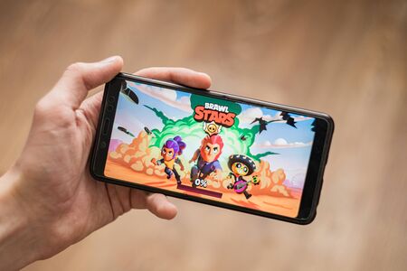 hand holding phone with brawl stars mobile gameのeditorial素材