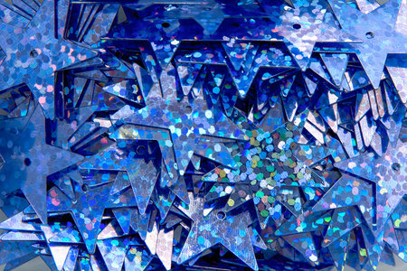 background of blue sewn-up stars with multi-colored splashes in defocus top view with blur for...
