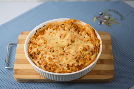 Lasagna with greens on a plate on a blue napkin, macaroni with chicken forcemeatの写真素材