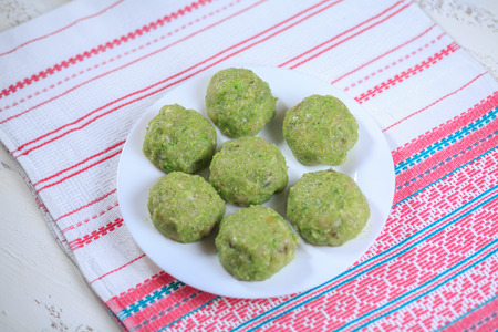 Crude forcemeat cutlet with a stuffing on a plate on a light backgroundの写真素材