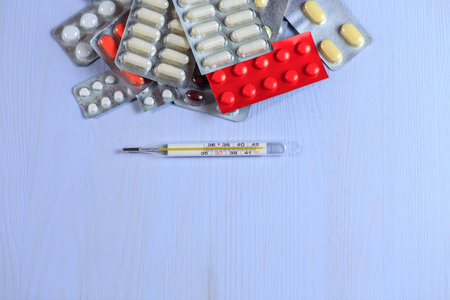 Medicines on a blue wooden background
