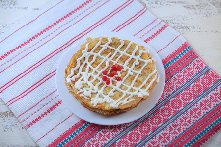 The Russian pancakes with a stuffing on a white plate on a light background. Maslenitsa.の写真素材