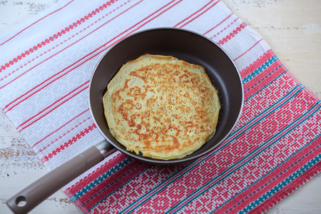 The Russian pancakes with a stuffing on a white plate on a light background. Maslenitsa.の写真素材