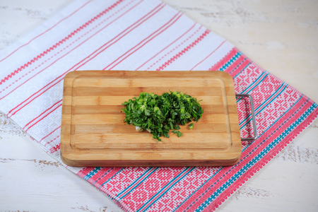 Greens fresh on a wooden board on a table. Parsley, fennel.の写真素材