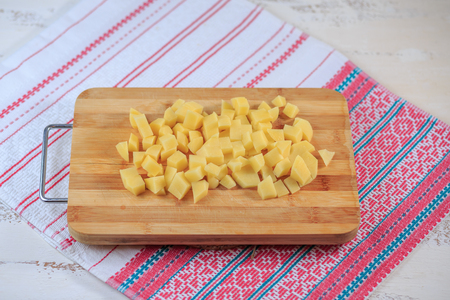 Potatoes fresh on a wooden board on a table.の写真素材