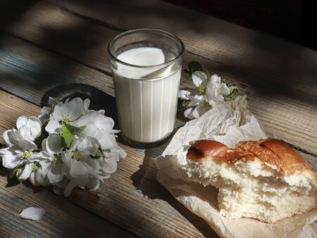 Milk in a glass bottle on wooden backgroundの写真素材