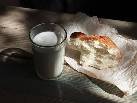 Milk in a glass bottle on wooden backgroundの写真素材