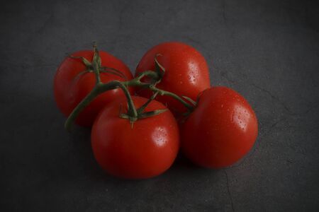The concept of making a salad from vegetables. vegetarian food. resh tomatoes on a plate among the greens.の写真素材