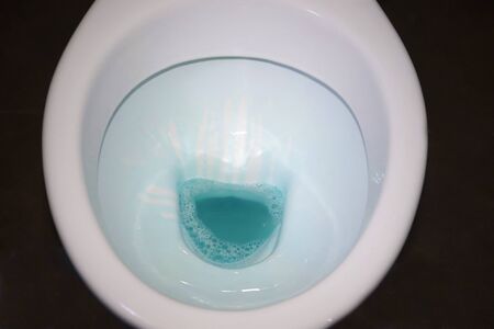 toilet close-up with disinfectant. the process of cleaning in the bathroom, the rest room,の写真素材