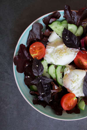 Diet breakfast. poached eggs, tomato, lettuce on a plate. View from above. fresh vegetables for lunchの写真素材