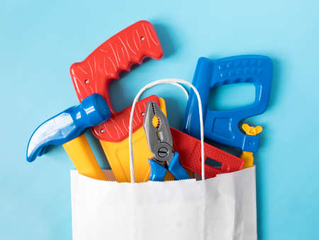 set of toy tools for the boy in the packing bag. the concept of parents buying toys for children. place for text, shopping,の写真素材