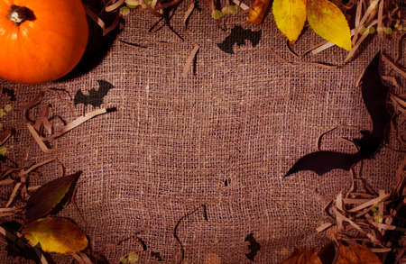 Halloween background brown baggy. orange pumpkin and bat around. View from above. Flatley. Happy Halloween. copy space, texture backgroundの写真素材