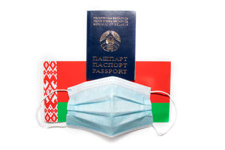 The flag of the Republic of Belarus, passport and medical mask. The concept of border closures due to the covid-19 coronavirus epidemicの写真素材