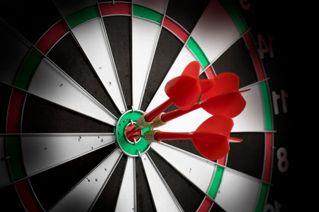 Three darts hitting right at the target. The concept of success, achievement of goals, realization...