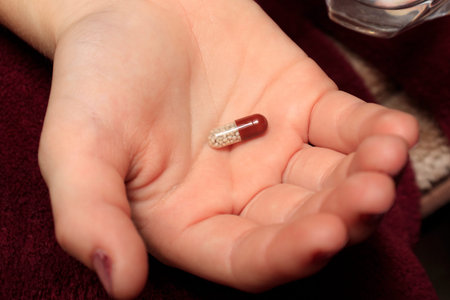 Pill, capsule lying in the hand close-up. The concept of taking painkillers, medications, treatment...