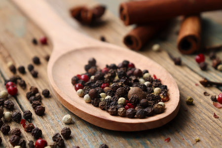 Pepper-and-pepper mixture. Black, red and white peppercorns. mixed of peppercorns in a spoon on a...