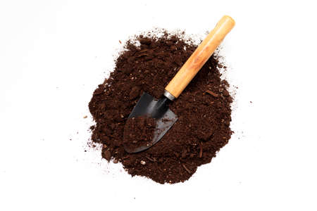 Soil for planting plants and garden blade on a white background. The concept of the beginning of planting works, growing seedlings, transplanting flowers, soil selectionの写真素材