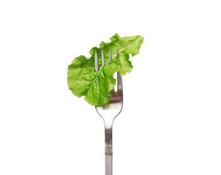 Fresh salad on a fork. isolated. Concept of healthy diet, weight loss and clean eating, balanced nutrition. Vegetables on a fork. healthy foodの写真素材