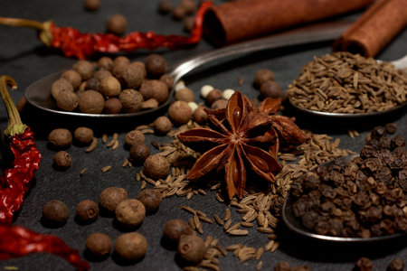 A set of different spices close-up on a dark table. spice background. Banner. Oriental Spice Market....