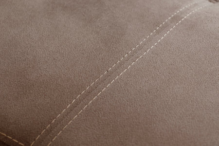 Stitch on beige fabric backgroundの写真素材