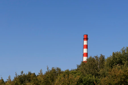 Thermal Station. High red and white tube against the sky, A non-working smoke pipe.の写真素材