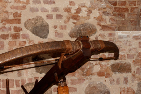 An antique crossbow against the background of a stone wall