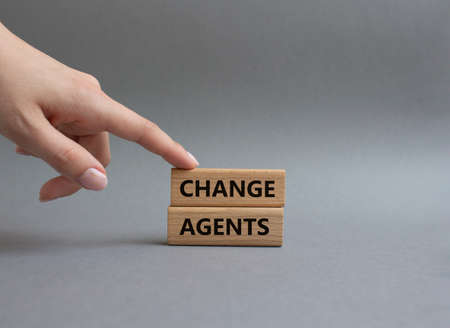 Change agents symbol. Concept word Change agents on wooden blocks. Beautiful grey background. Businessman hand. Business and Change agents concept. Copy spaceの写真素材