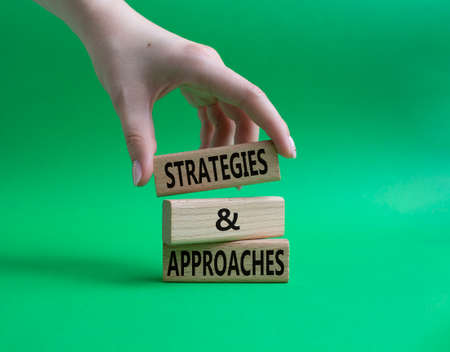 Flexible and agile symbol. Concept word Flexible and agile on wooden blocks. Beautiful green background. Businessman hand. Business and Flexible and agile concept. Copy spaceの写真素材