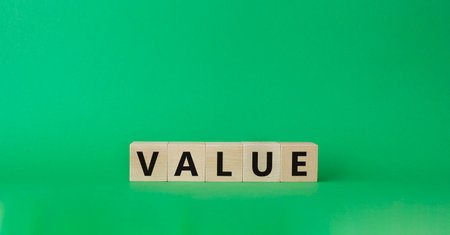 Value symbol. Concept word value on wooden cubes. Beautiful green background. Business and value concept. Copy space.の写真素材