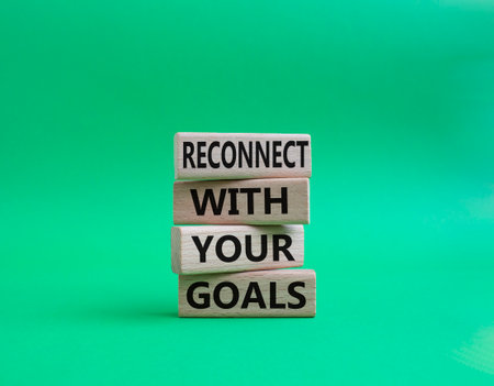 Goals symbol. Wooden blocks with words 'Reconnect with your goals'. Beautiful green background. Business and 'Reconnect with your goals' concept. Copy space.の写真素材