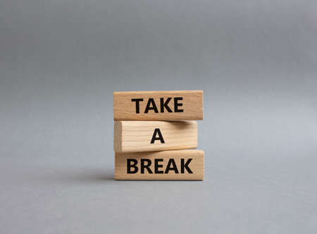 Take a break symbol. Concept words 'Take a break' on wooden blocks. Beautiful grey background. Business and Take a break concept. Copy space.の写真素材