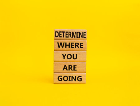 Determination symbol. Wooden blocks with words Determine where you are going. Beautiful yellow background. Business and Determine where you are going concept. Copy spaceの写真素材
